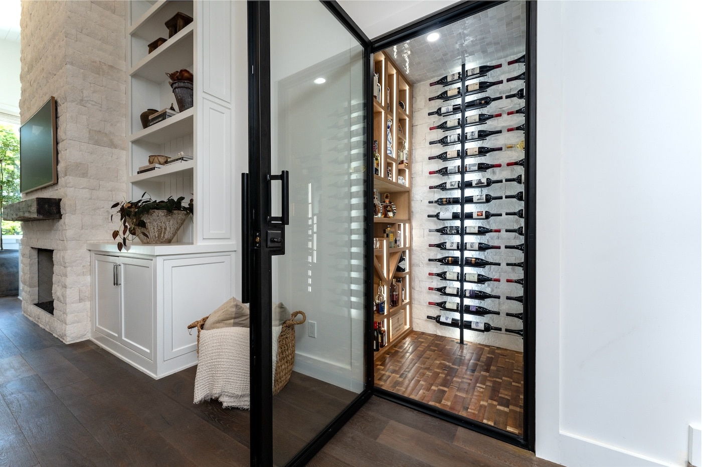 Custom wine room in Houston with walnut joinery and low-iron glass